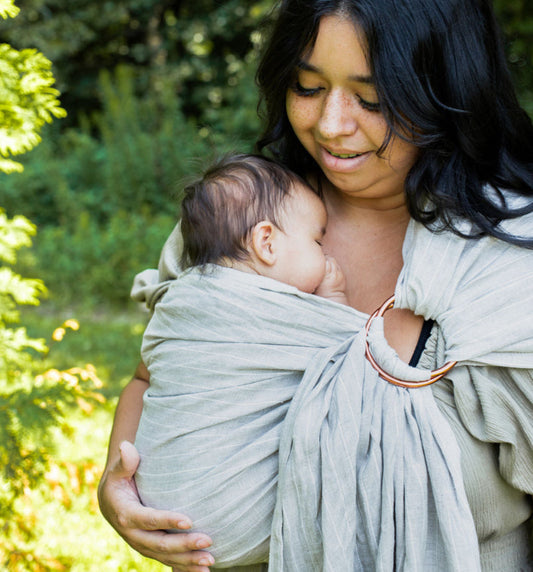 mom carrying baby in linen ring sling