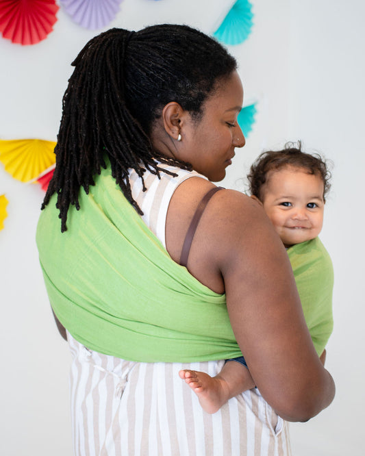 Black Woman wearing Baby in Ring Sling