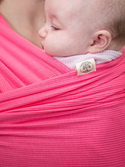 close up of heritage baby designs tencel stretch wrap baby carrier in pink