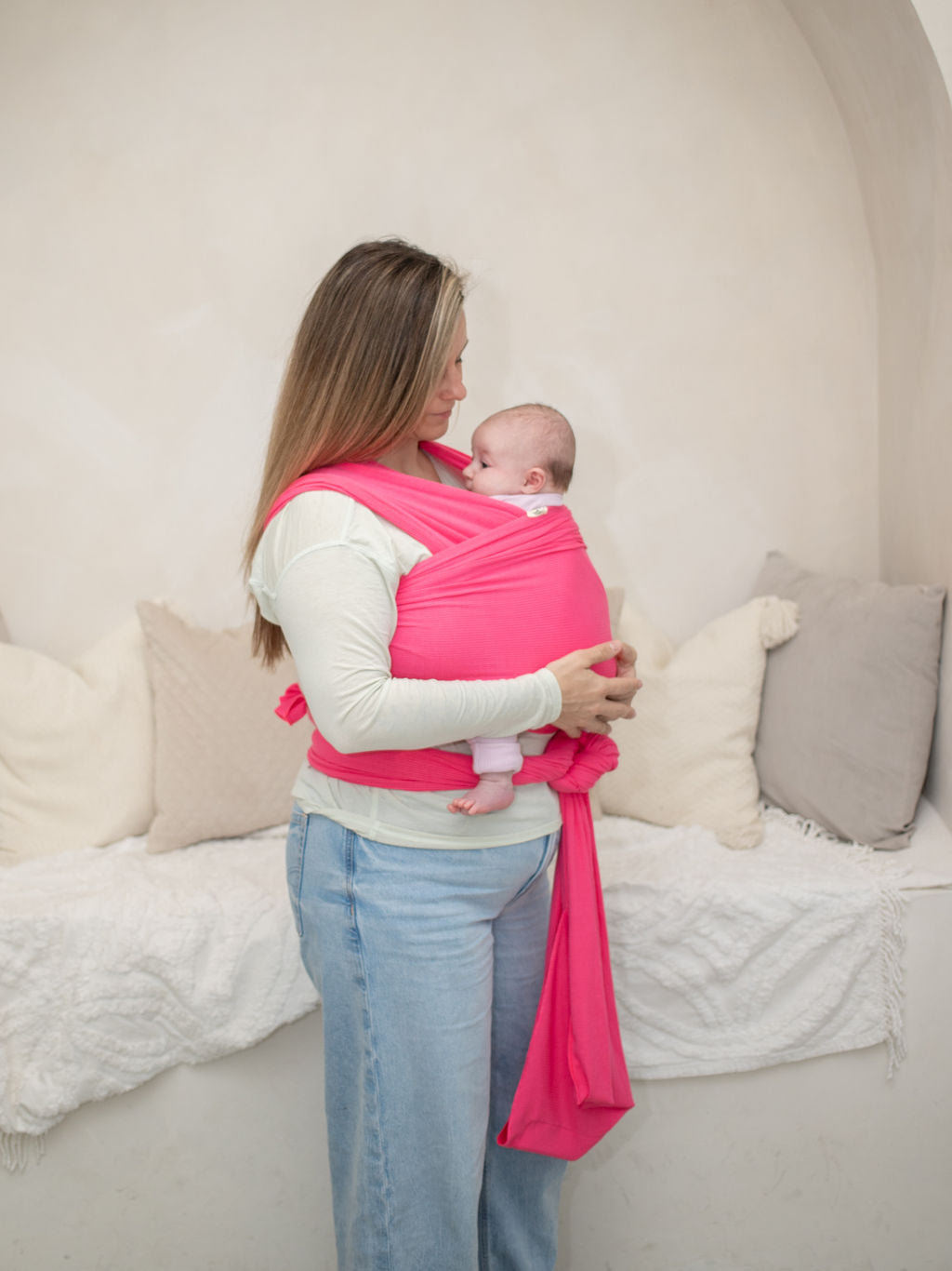 full body view of mom wearing heritage baby designs wrap carrier, with baby. 