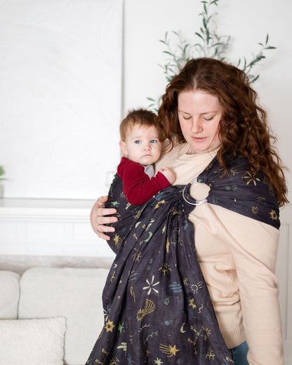 mom wearing a grey-navy double layer linen ring sling with a hand drawn celestial print