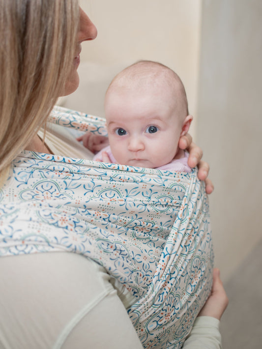 close up of mom wearing baby in stretchy Wrap Carrier Mediterranean Tile Inspired Print 