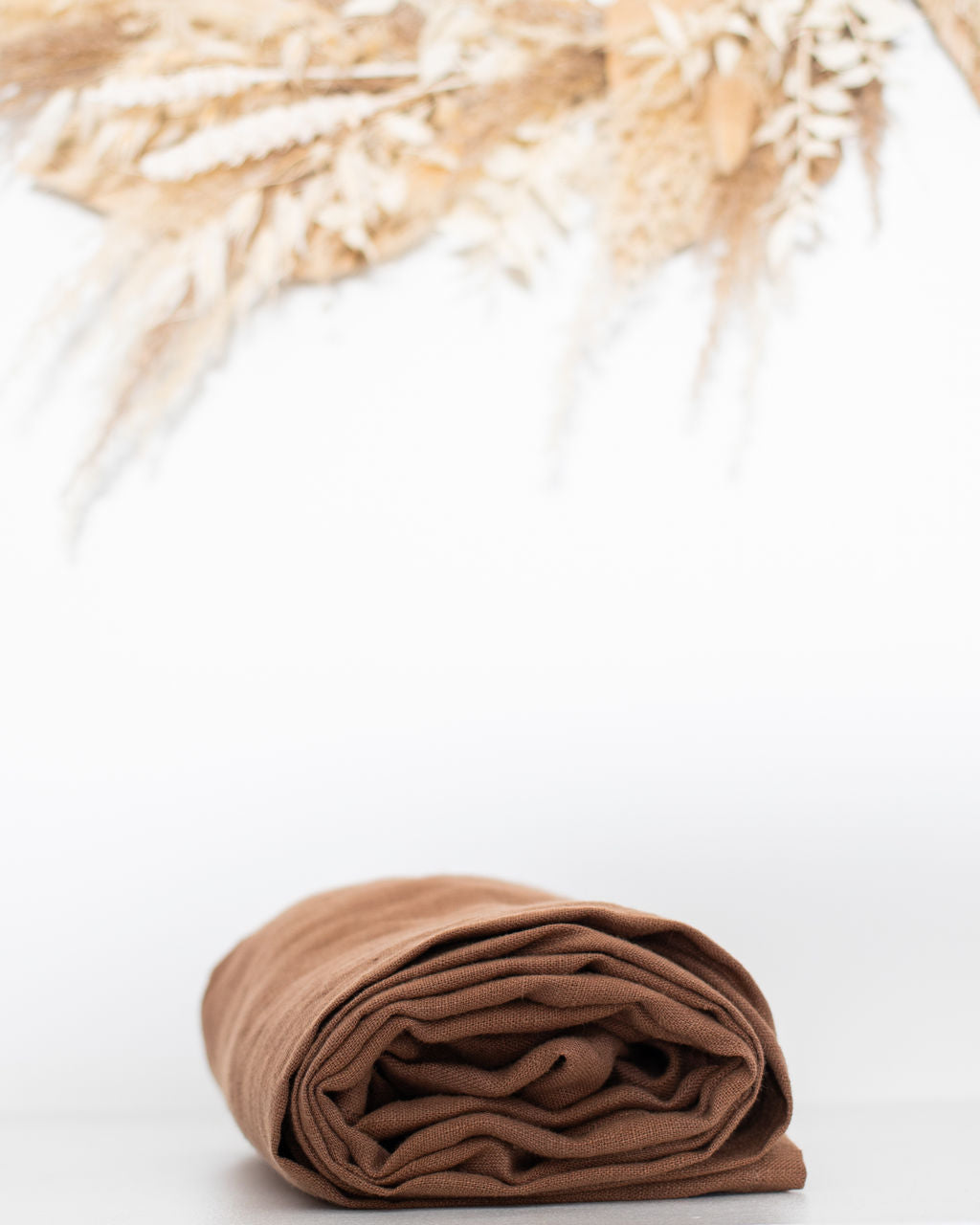 brown linen ring sling on a white background 